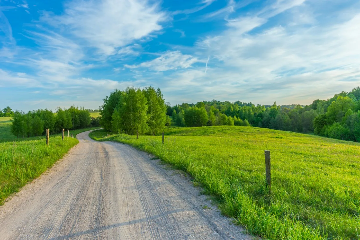 Gravel access road through green countryside