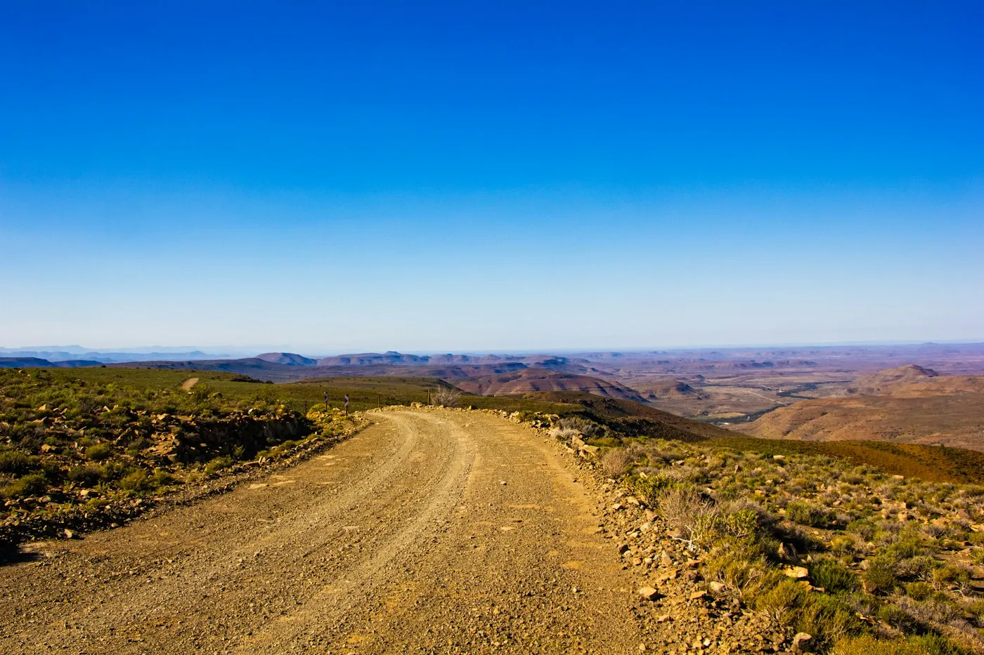 Unpaved road across dry terrain